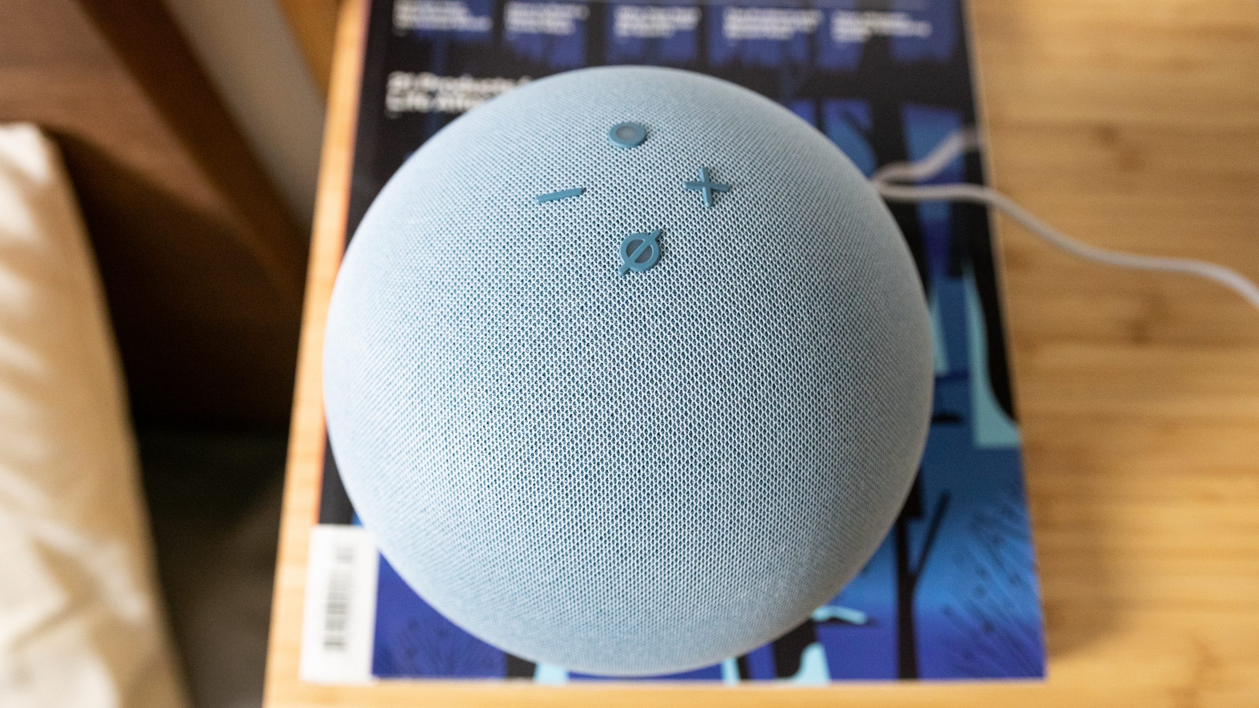 Amazon Echo 4th gen on top of a magazine.