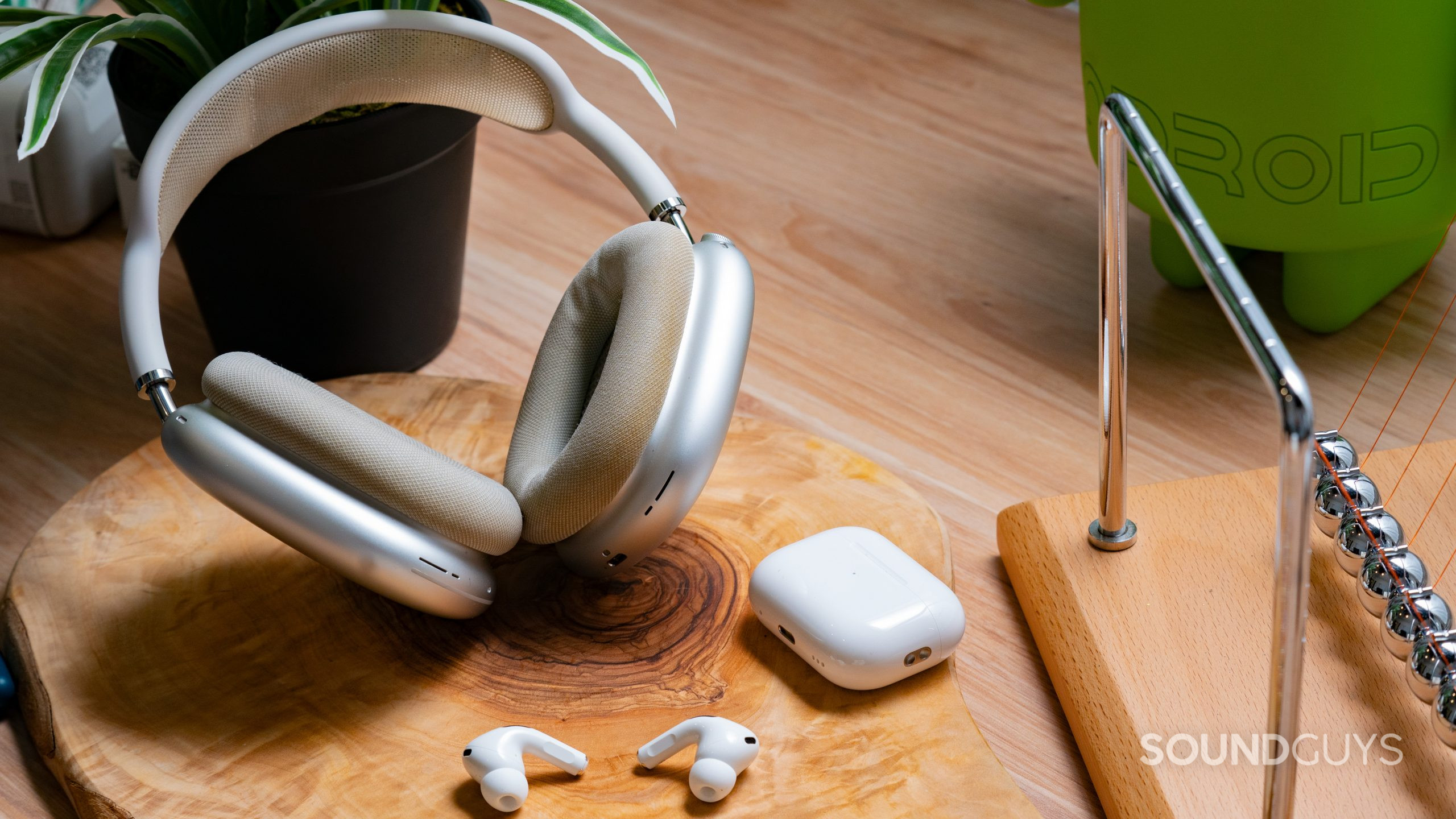 The AirPods Max and AirPods Pro (2nd generation) next to each other, with the AirPods Pro out of its case.