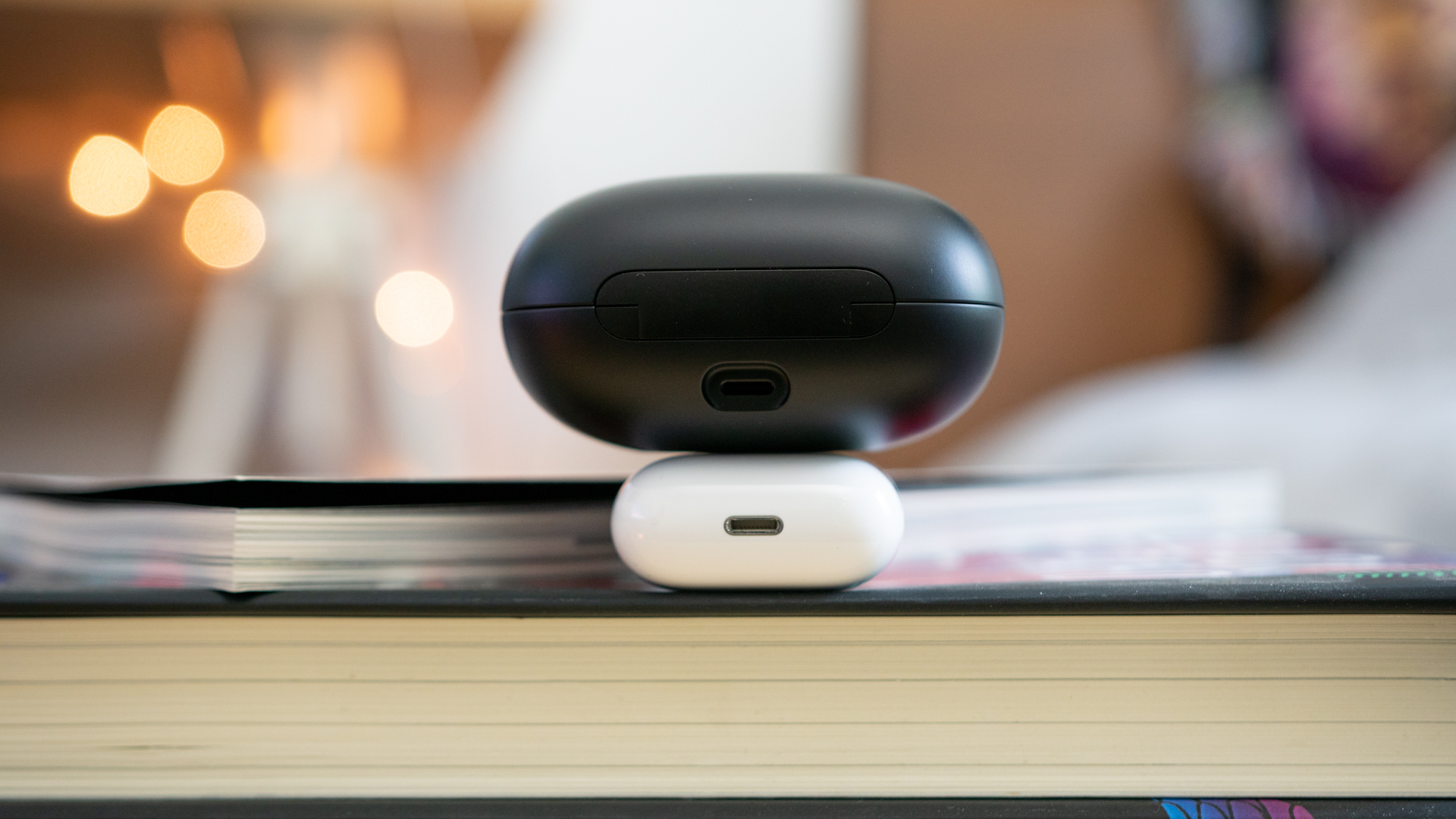 Close-up shot of the Lightning charging ports of both the Apple Airpods and the Powerbeats Pro