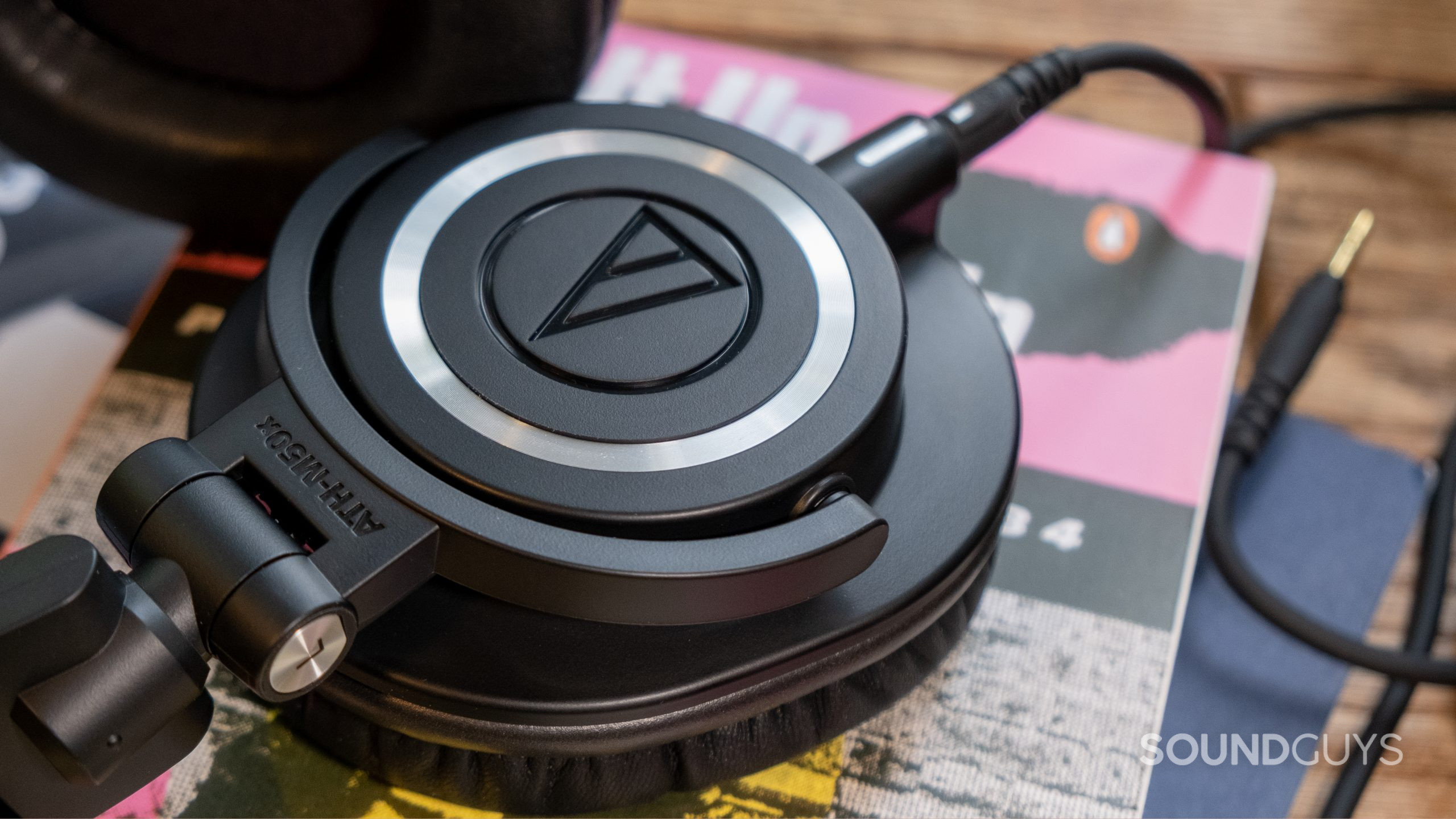 A close up of the Audio-Technica ATH-M50x shows the connection point of the cable.