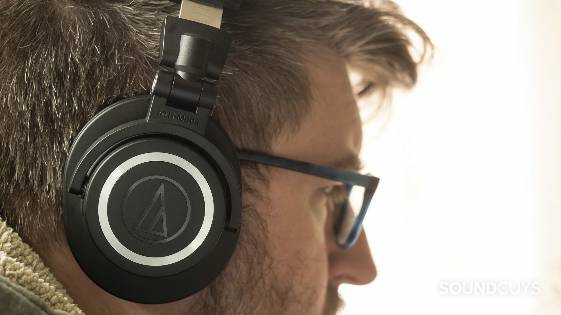 A photo of the Audio-Technica ATH-M50xBT on a man's head.