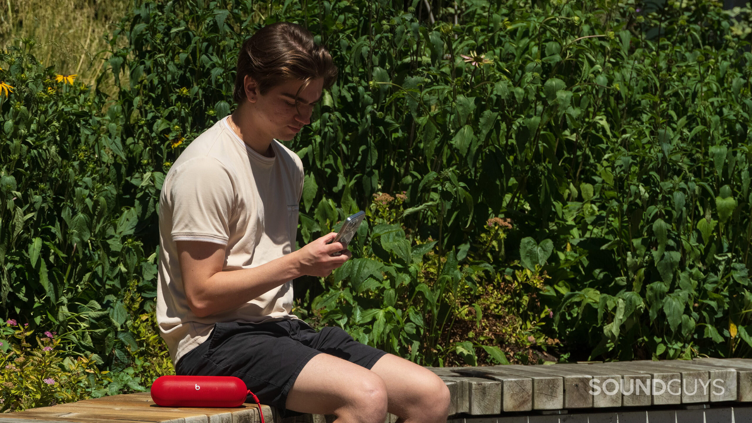 A man sitting next to a Beats Pill speaker.