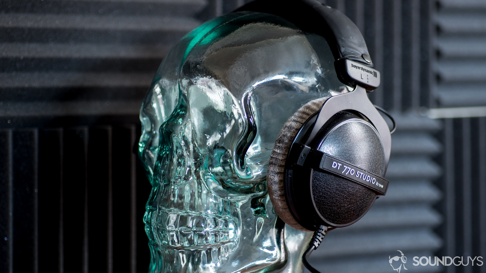 A photo of the Beyerdynamic DT 770 Studio 80 ohm sitting on a glass skull display.