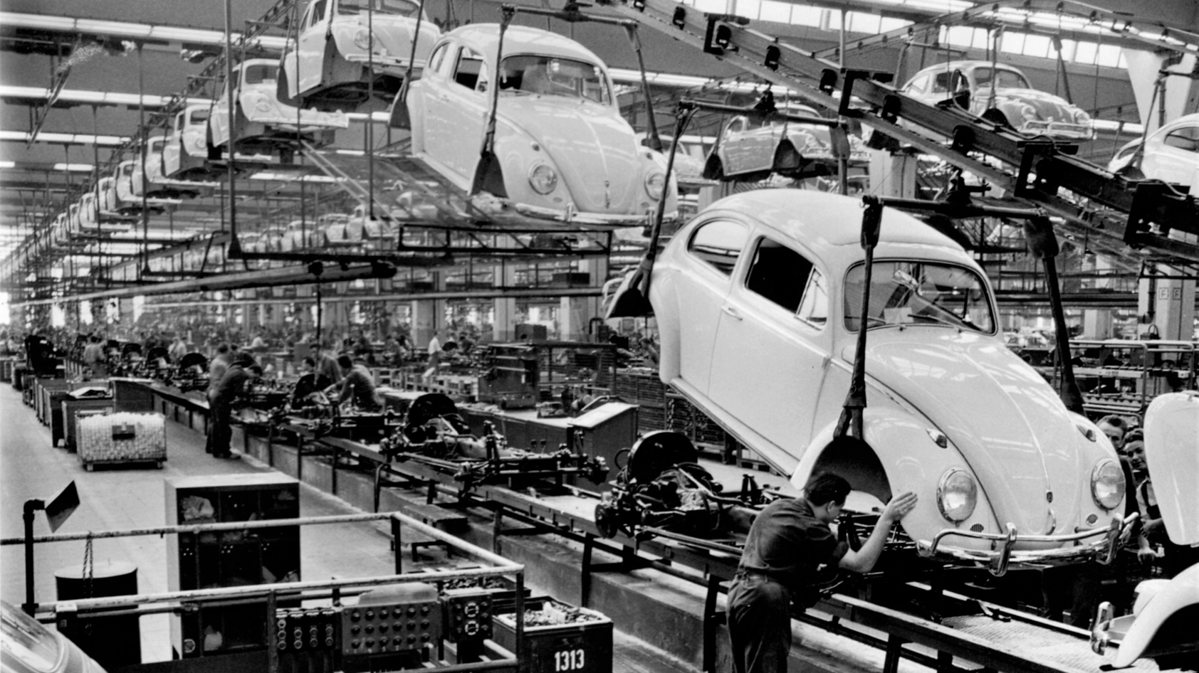 Headphone burn-in isn't real: Black and white image of car manufacturing plant.