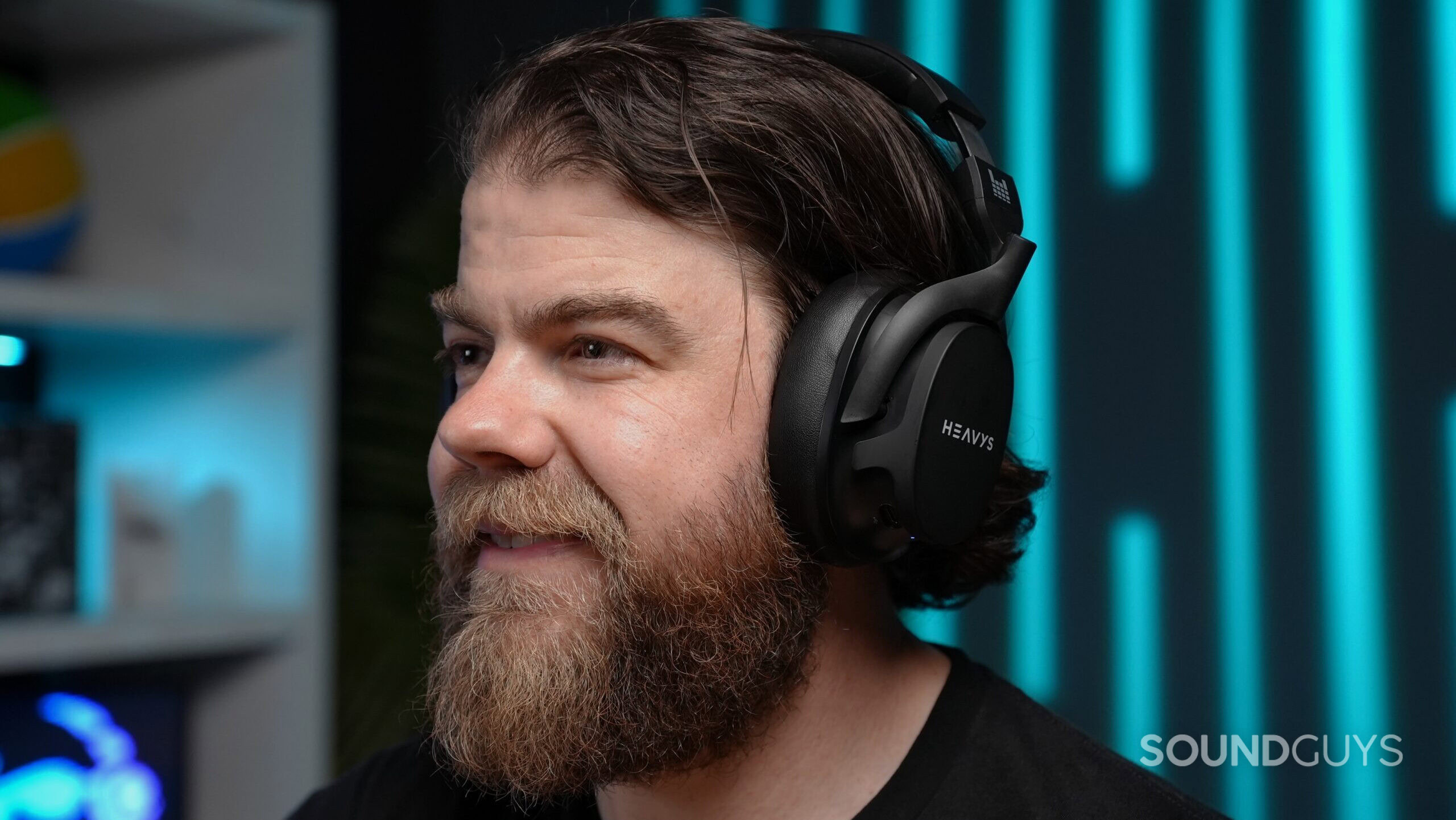 A man wearing the Heavy H1H headphones looking happy.