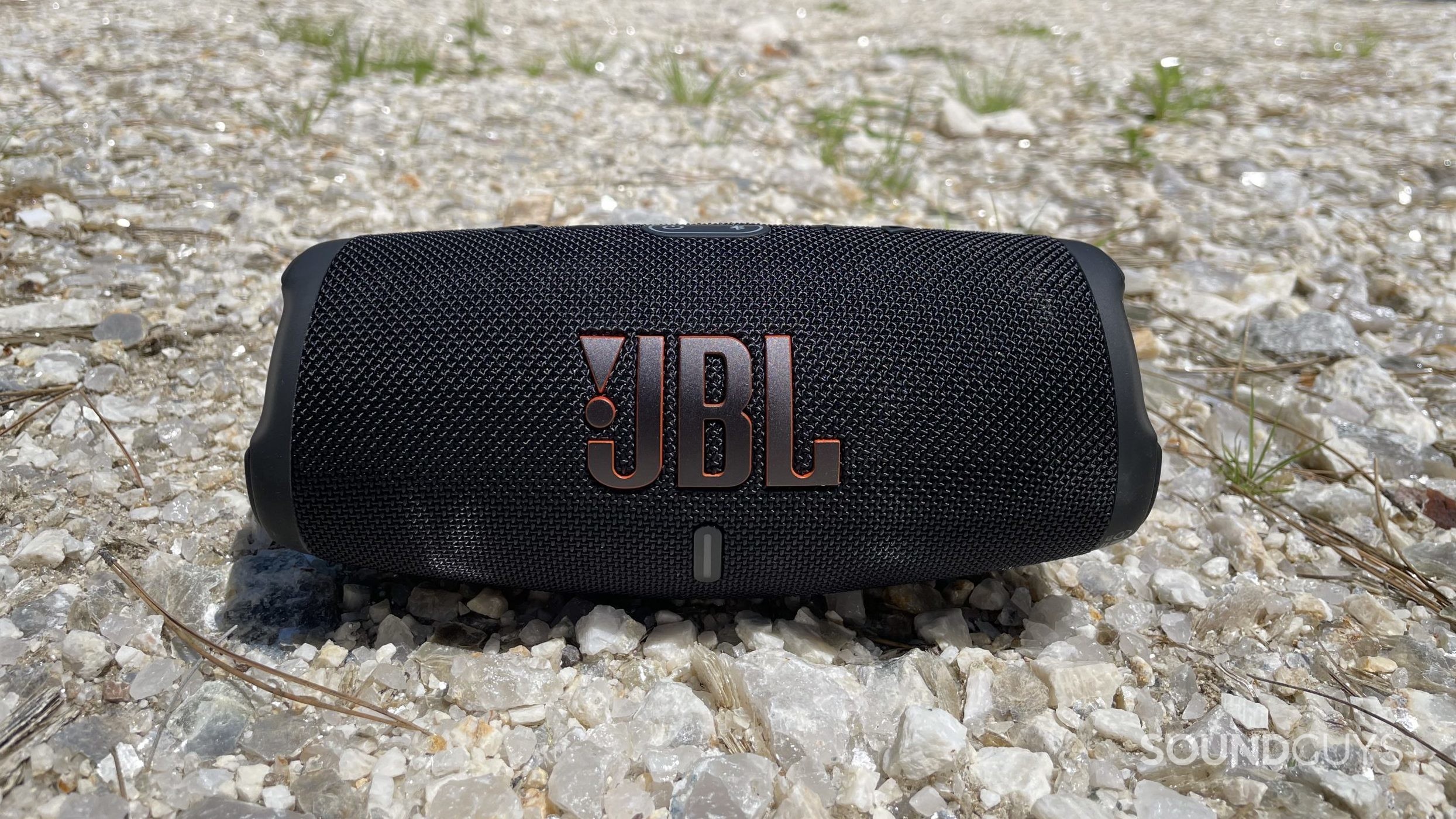 JBL Charge 5 resting on a bed of crystals.