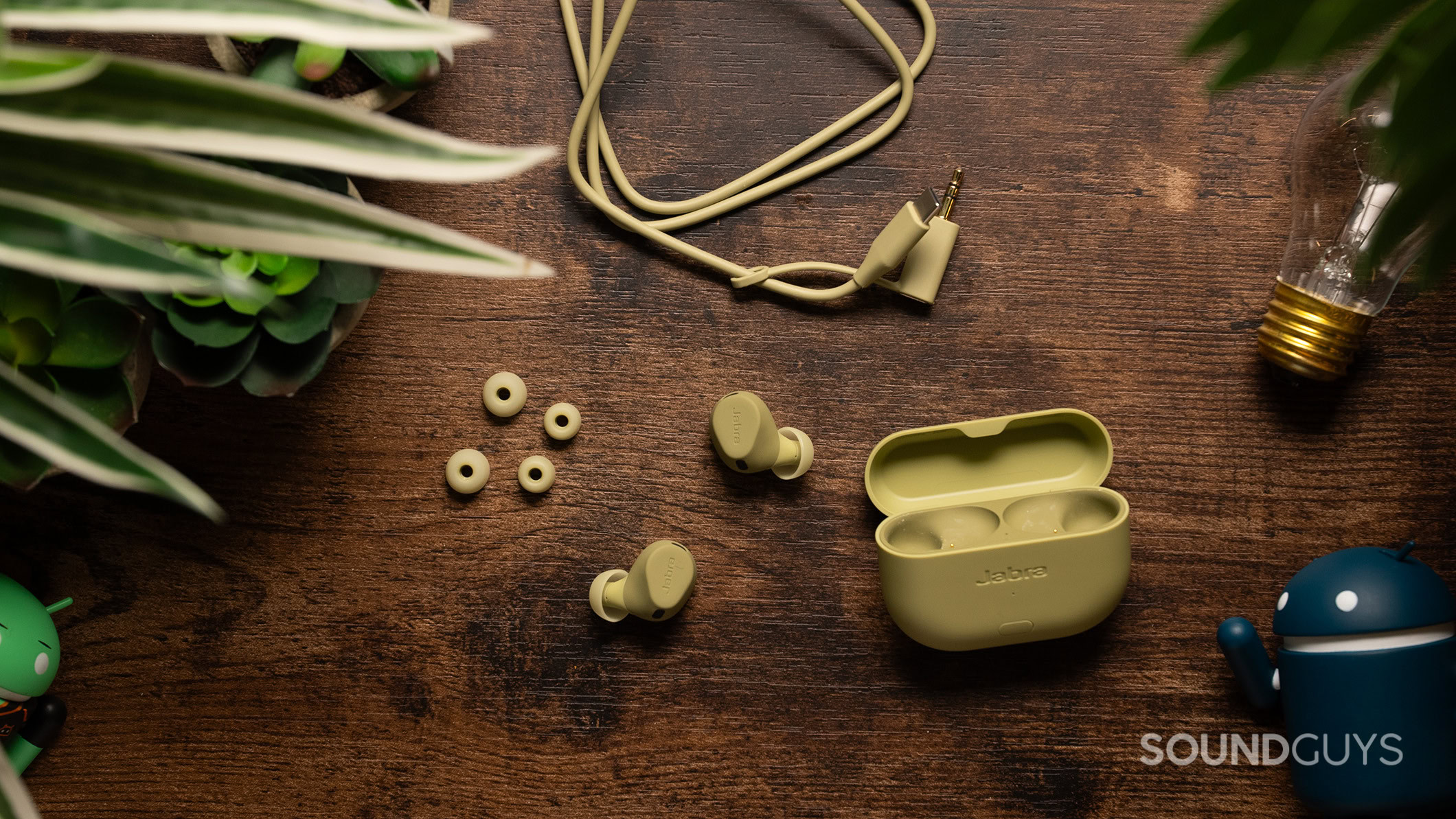 Jabra Elite 8 Active Gen 2 on a table with the extra ear tips and transmitter cable.