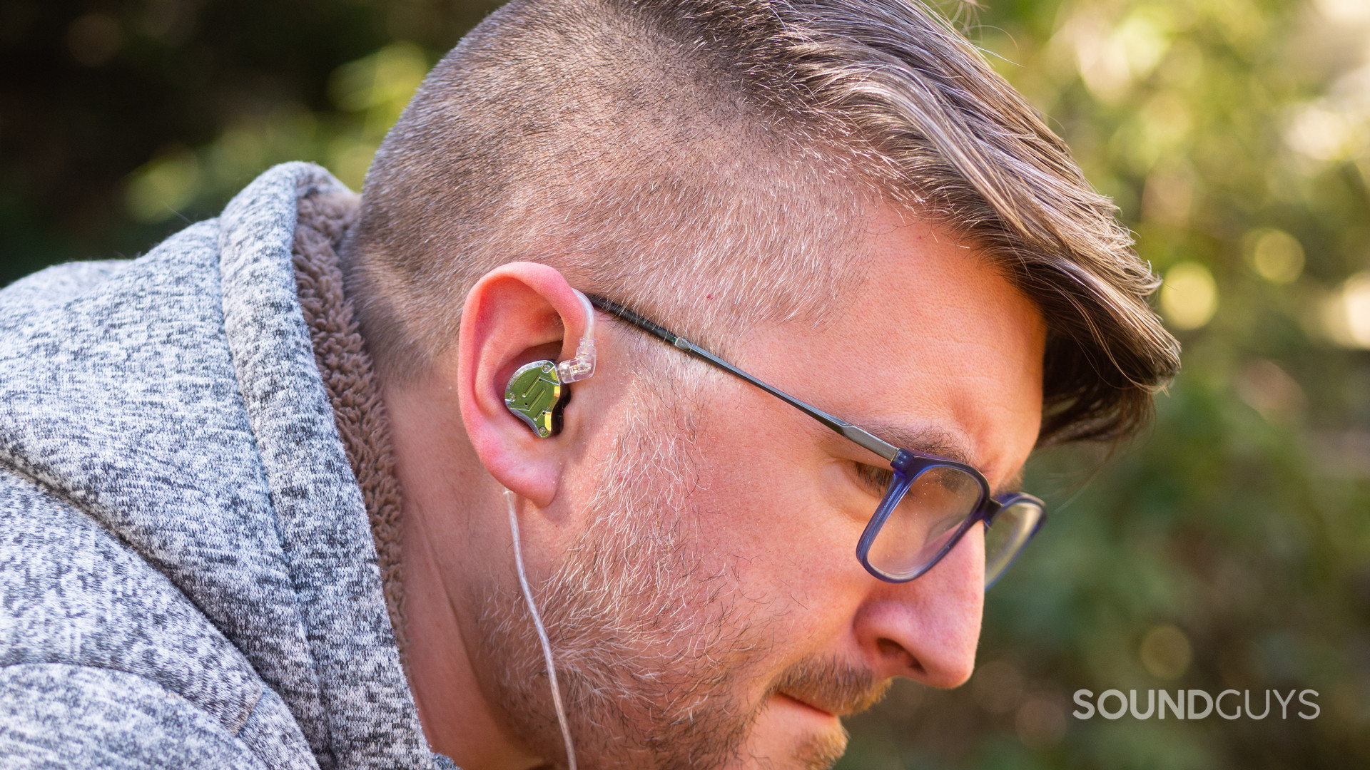 A man wears the KZ ZS10 Pro outdoors.