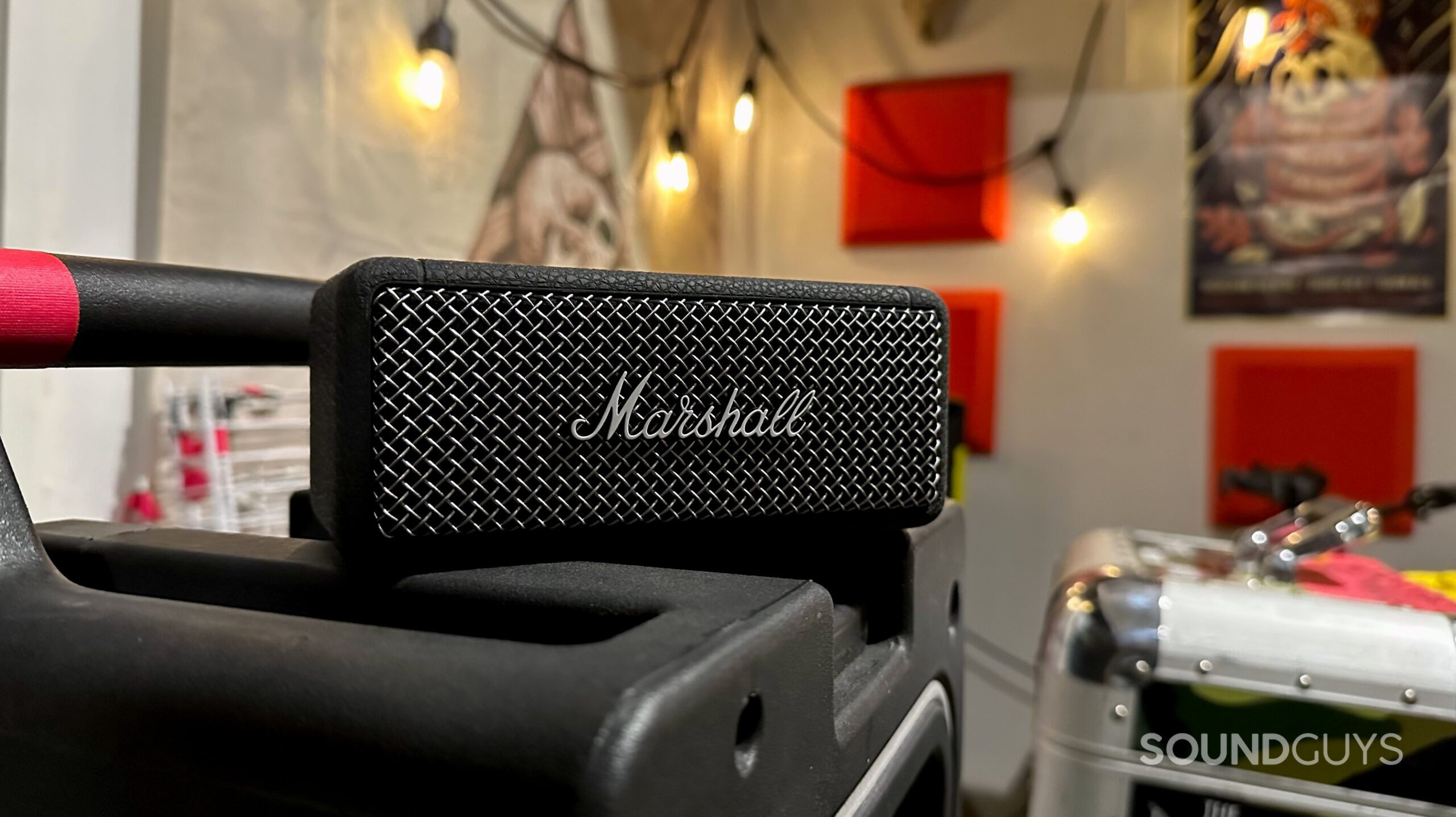 A Marshall Emberton II Bluetooth speaker placed on top of a road case.