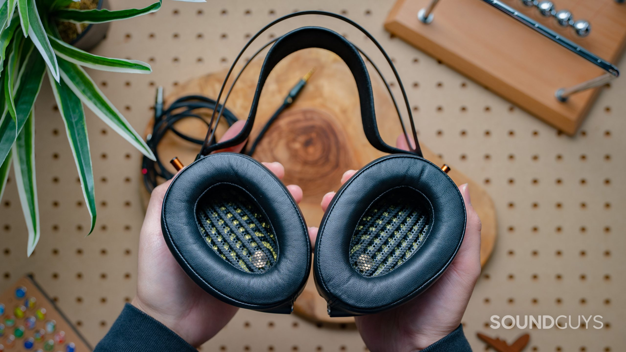 Meze Audio Empyrean Ear Cups shown held in hands