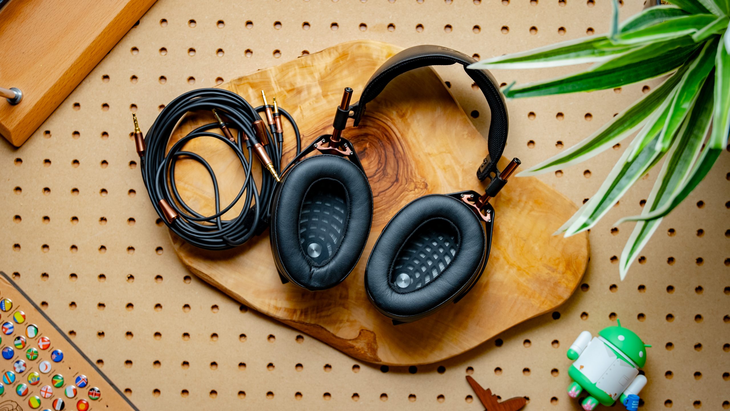 A photo of the Meze Audio Liric atop pegboard.