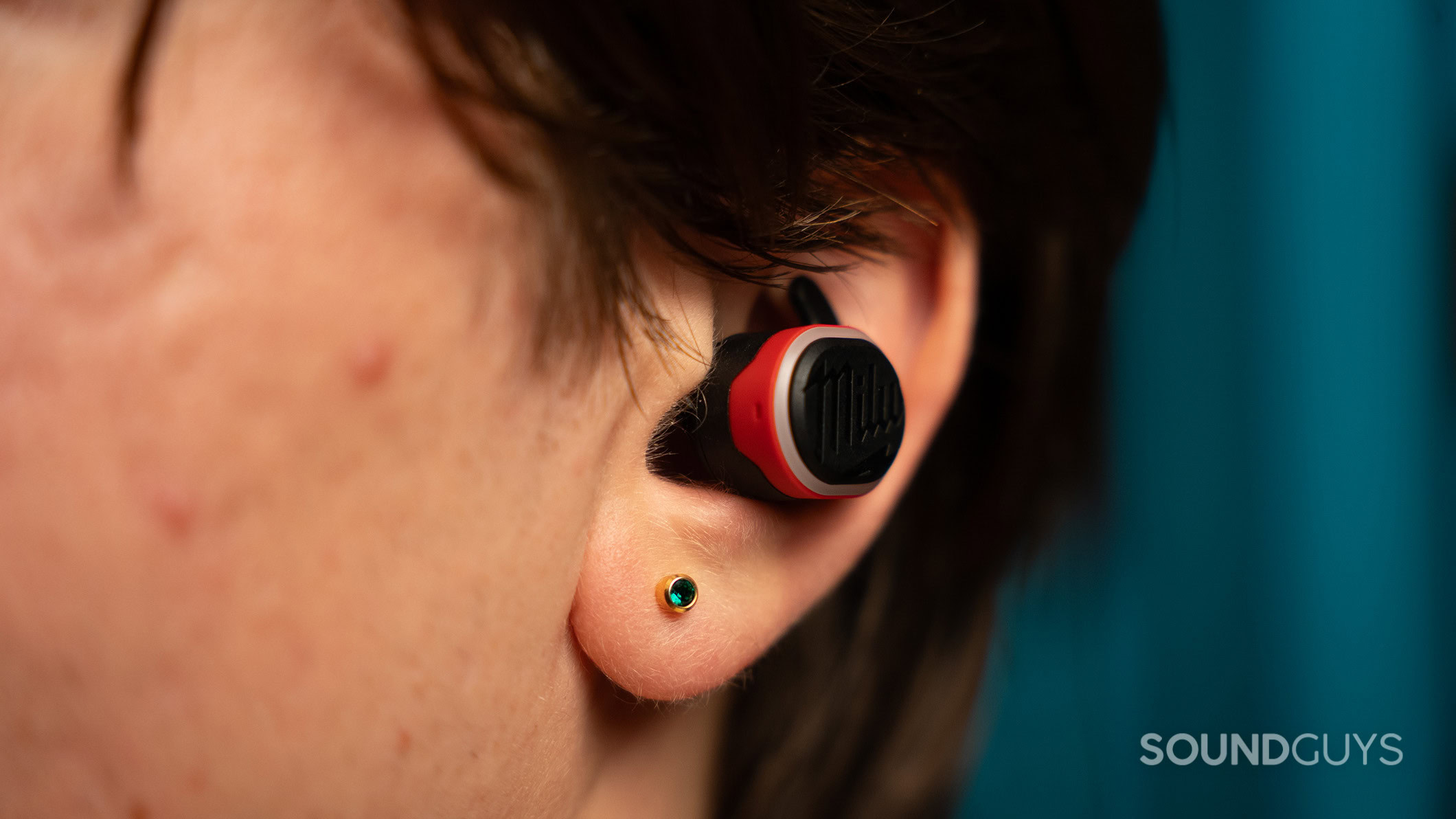 A close up of the Milwaukee earbuds in an ear. 