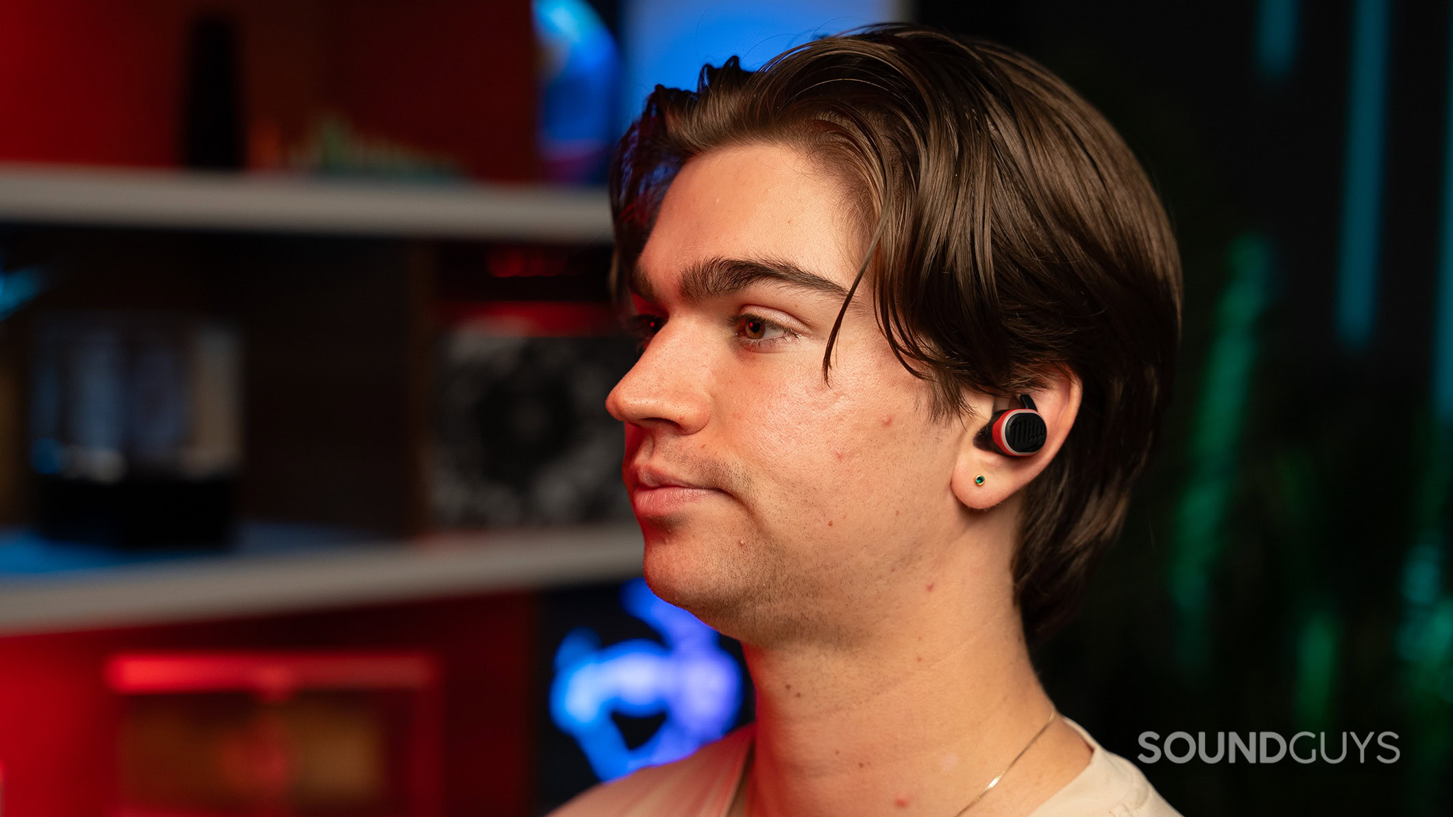 A man wearing the Milwaukee earbuds looking left. 