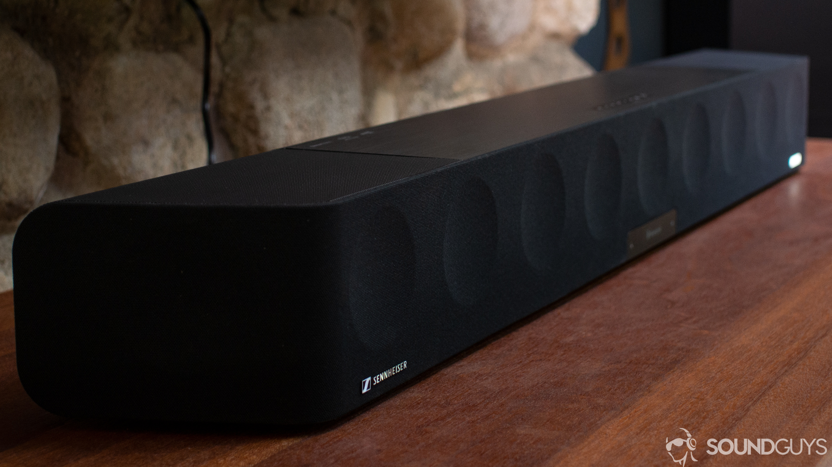 A photo of the Sennheiser Ambeo Soundbar on a wooden desk.