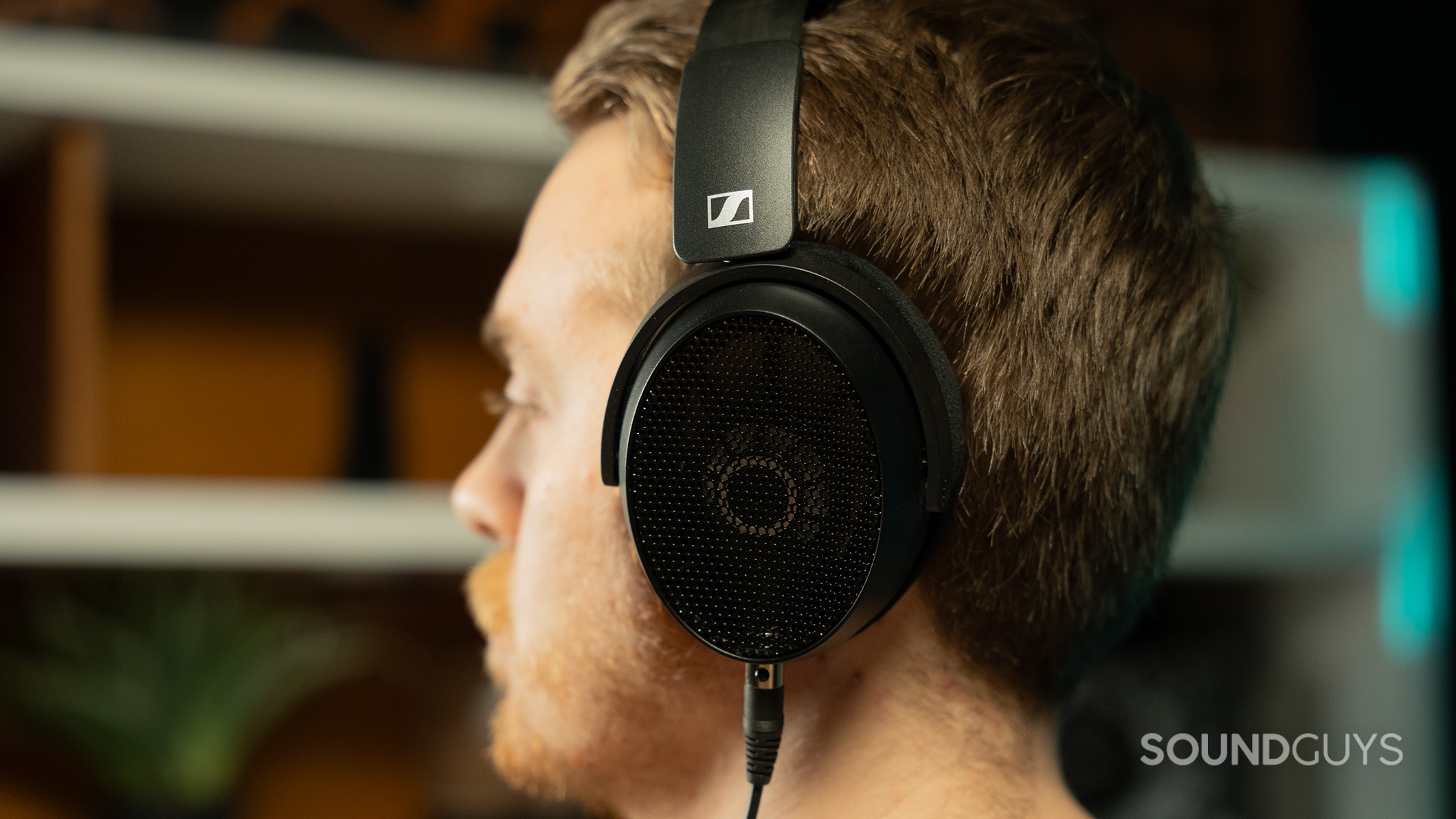 Sennheiser HD490 PRO headphones on man facing left.