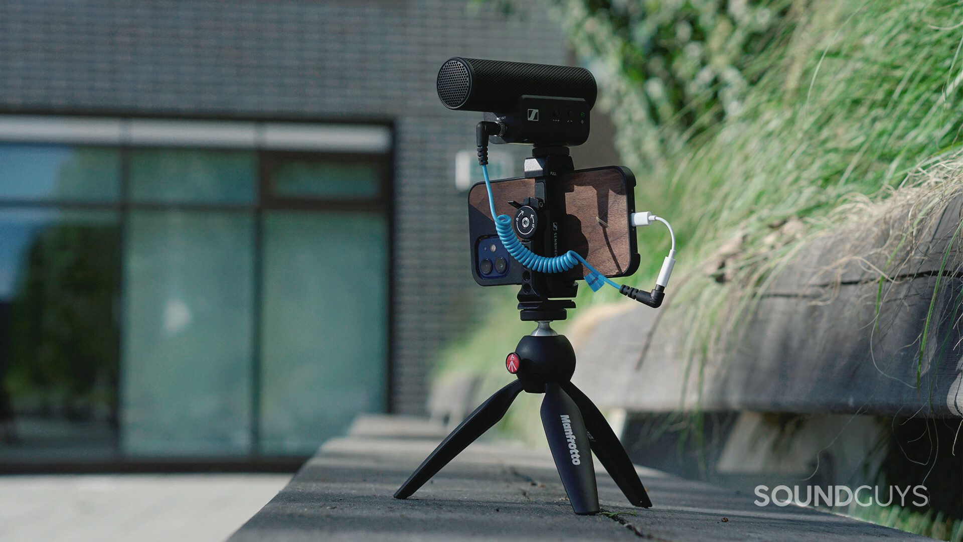 Sennheiser MKE 400 Mobile Kit on top of a wooden park bench