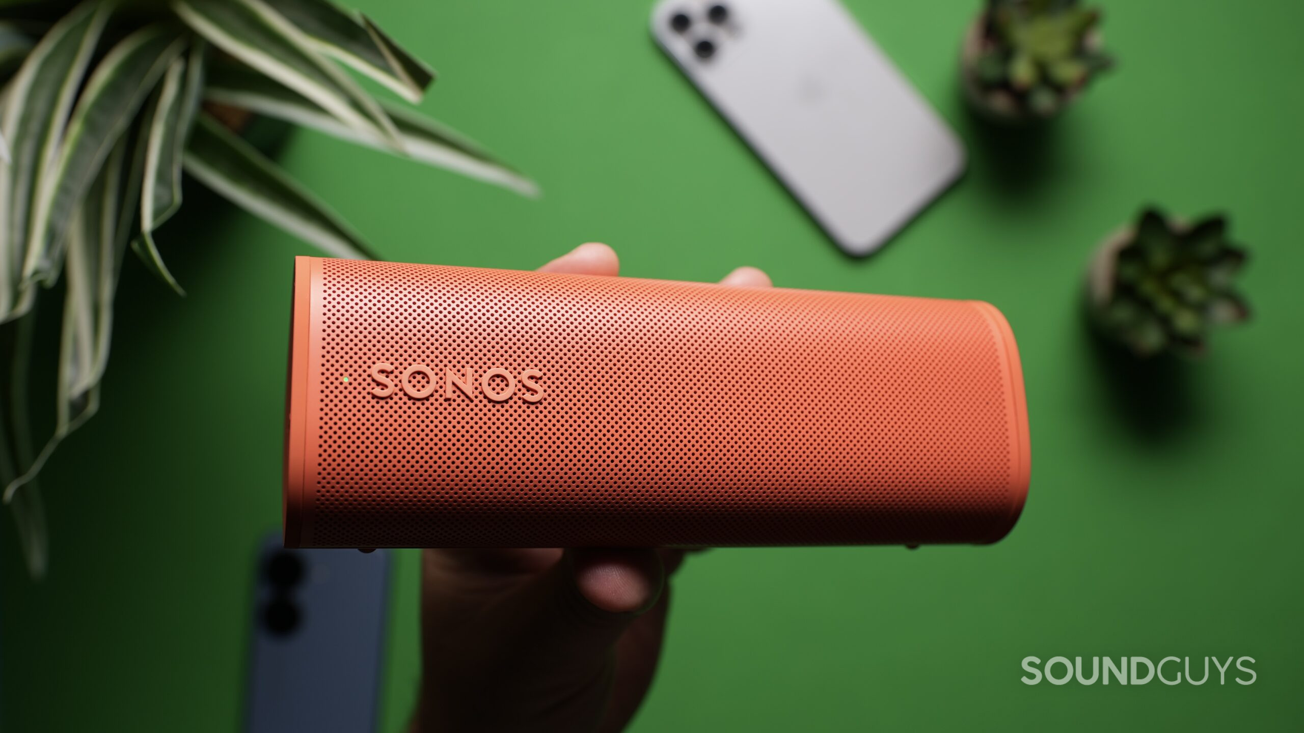 Top down photo of the Sonos Roam 2 held in a hand.