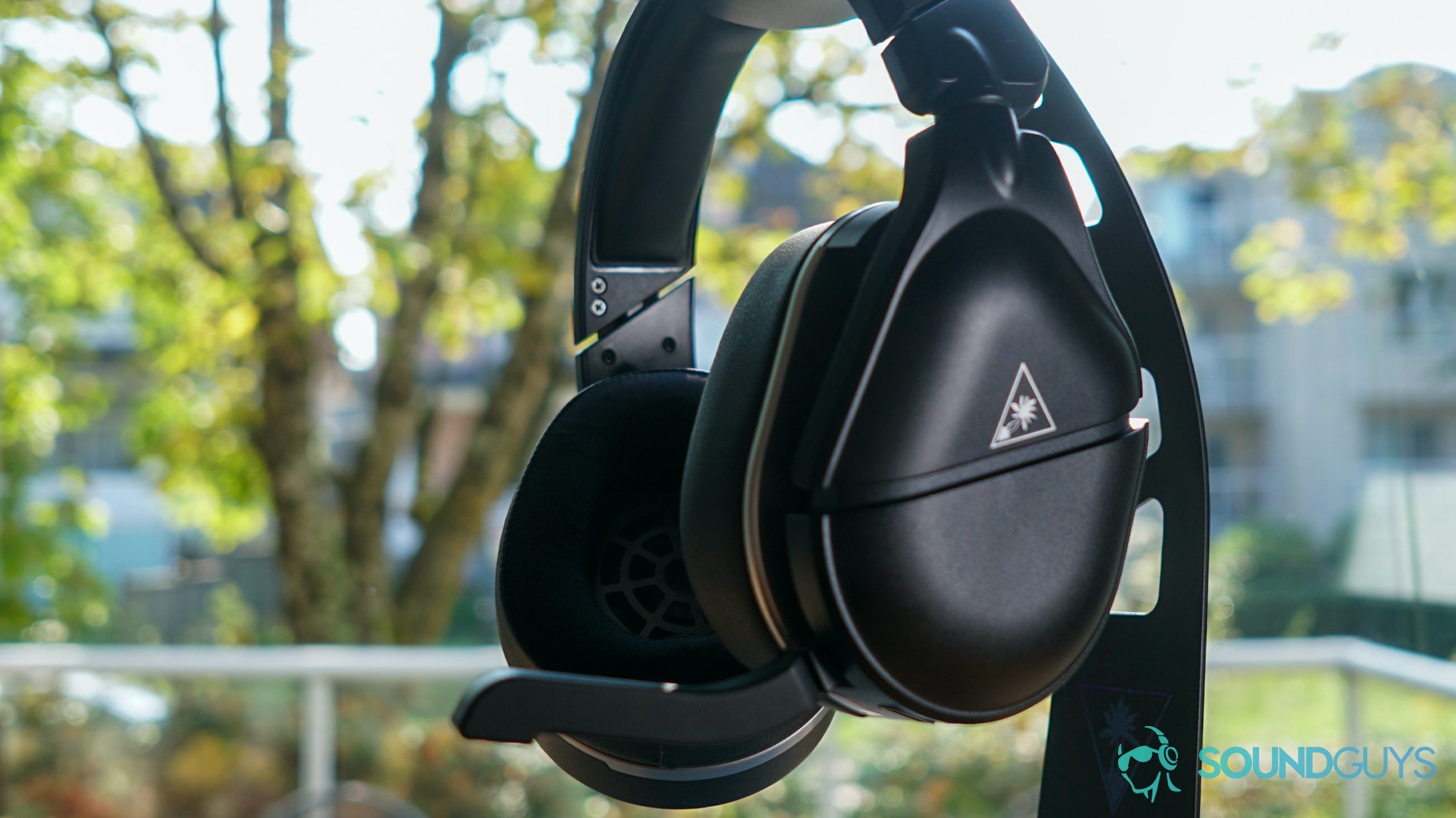 The Turtle Beach Stealth 700 Gen 2 headset against a backyard setting.