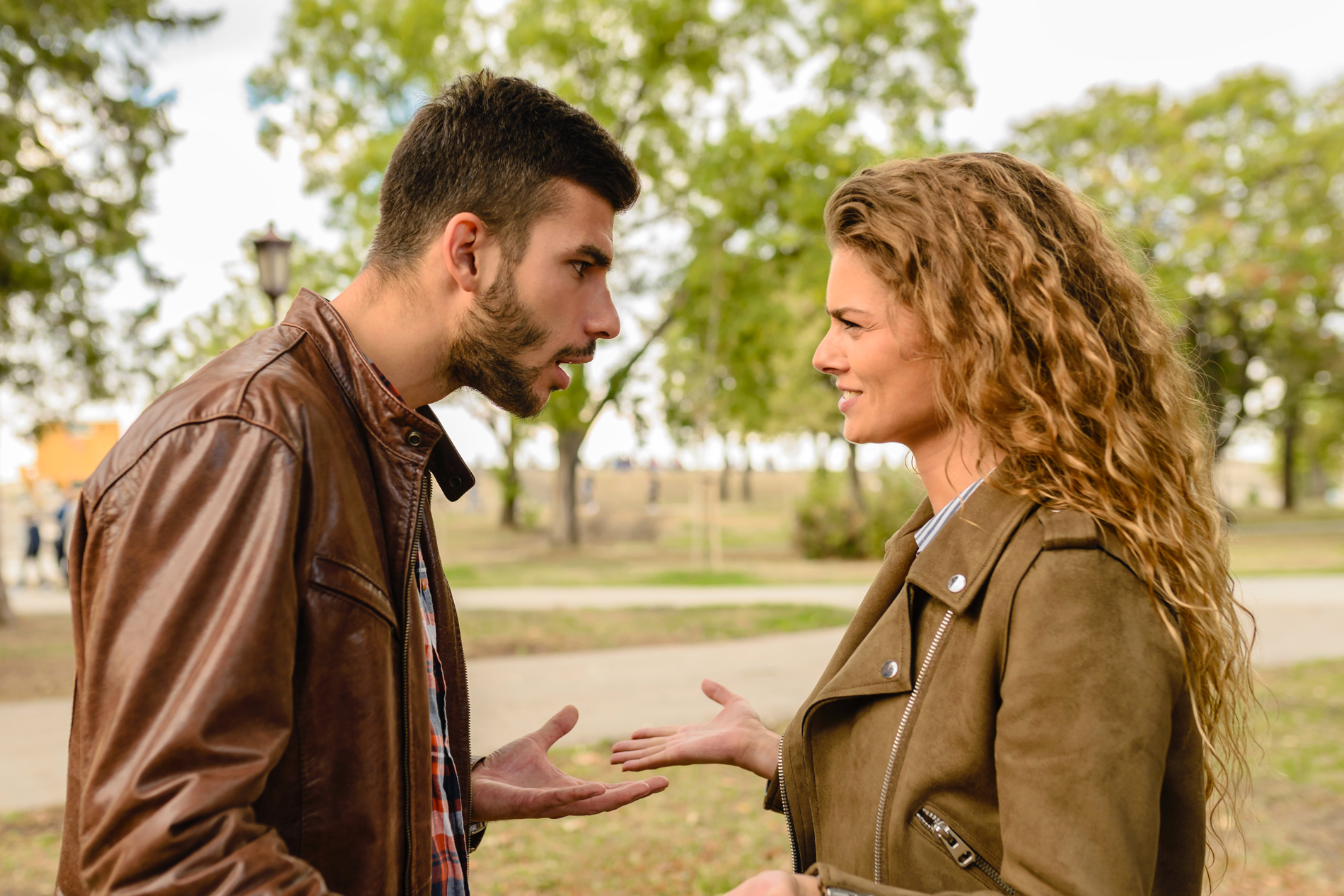 A photo of a man and a woman in an apparently heated conversation.