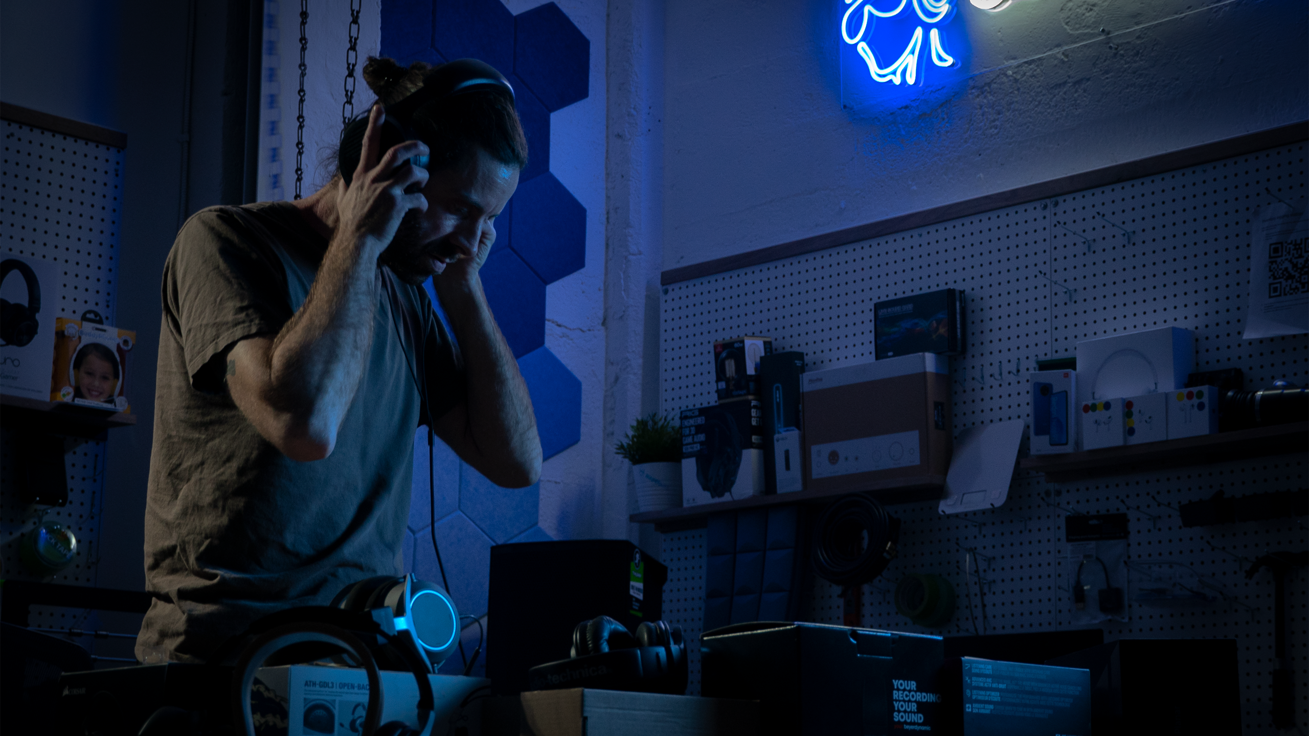 A headphone listener stands in a room.